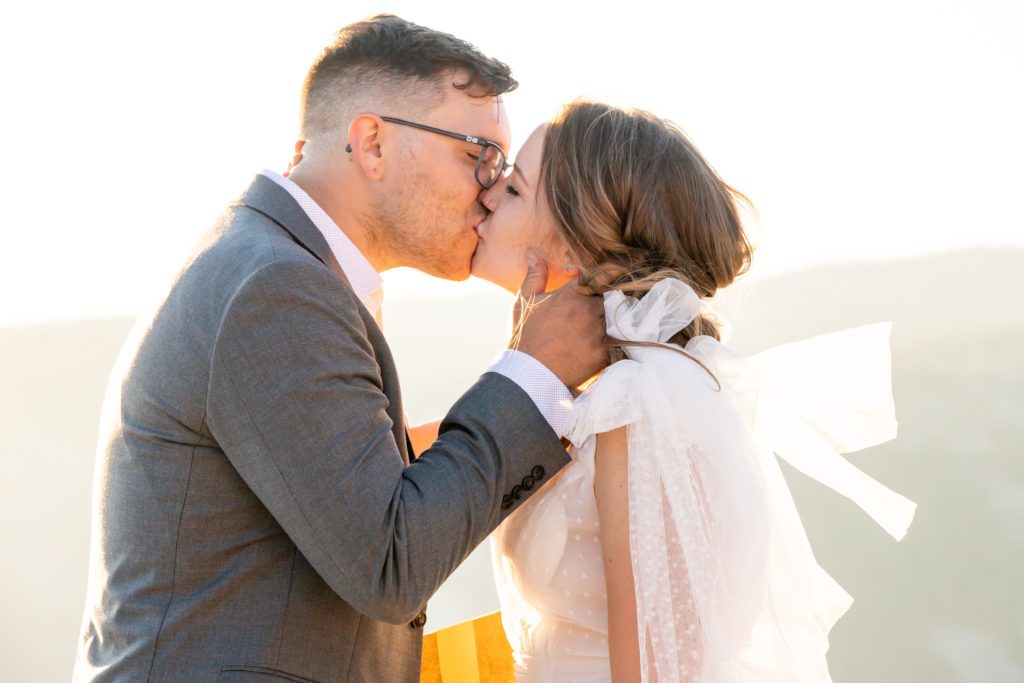 Groom kissing bride-Here's How to Elope: Advice from an Elopement Photographer